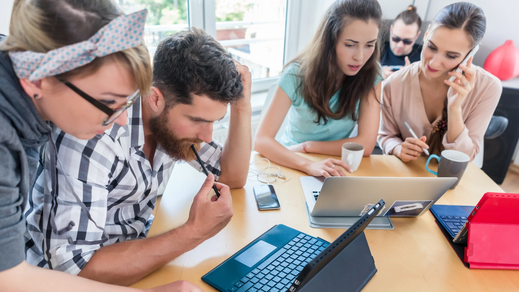 IT team collaborating around a laptop